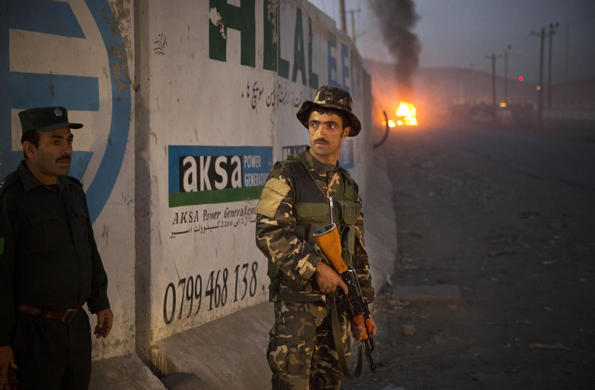 Afghan police secure the area after a car bomb detonated outside an ISAF civilian personnel compound in Kabul, Afghanistan, on Friday.