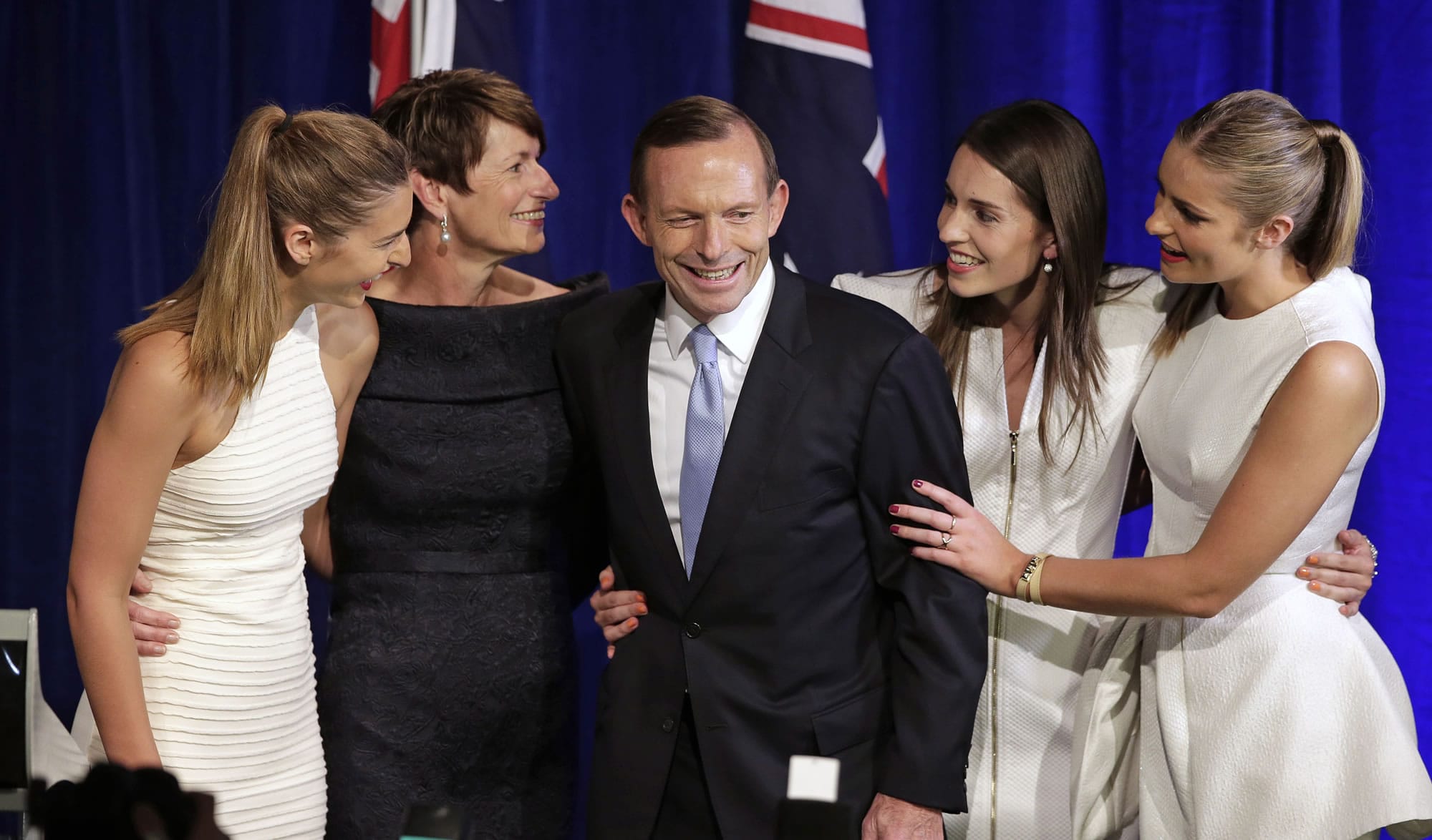 Tony Abbott, center, his wife, Margaret, in dark dress, and daughters, from left, Frances, Louise and Bridget celebrate his victory Saturday in Australia's national election.