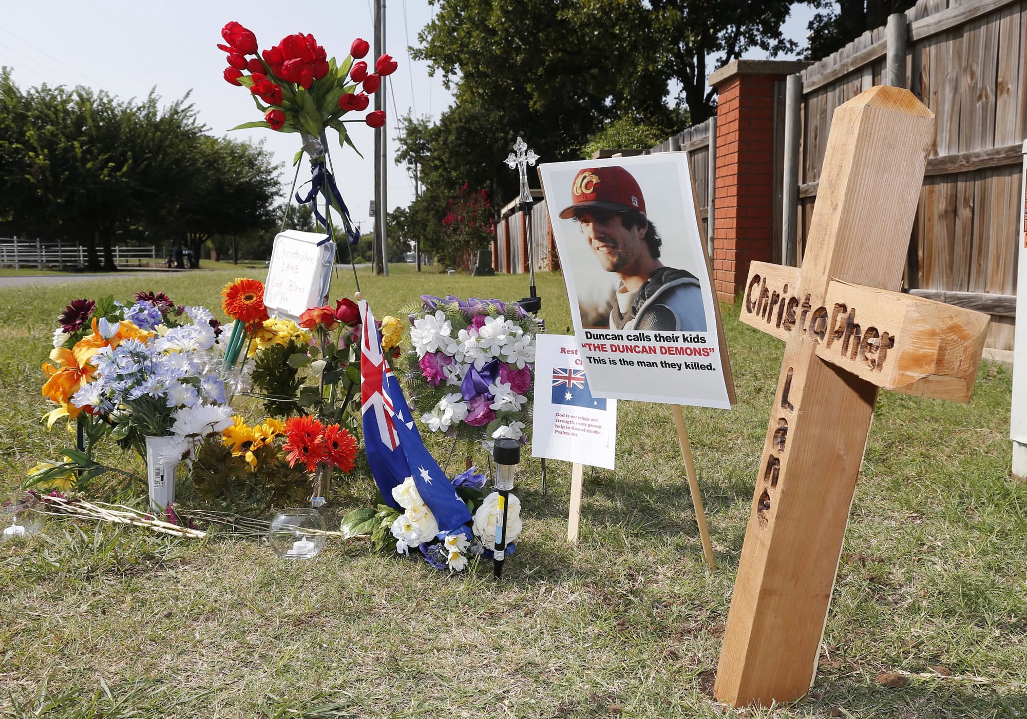 A memorial to Christopher Lane is shown Tuesday along the road where he was shot and killed in Duncan, Okla.