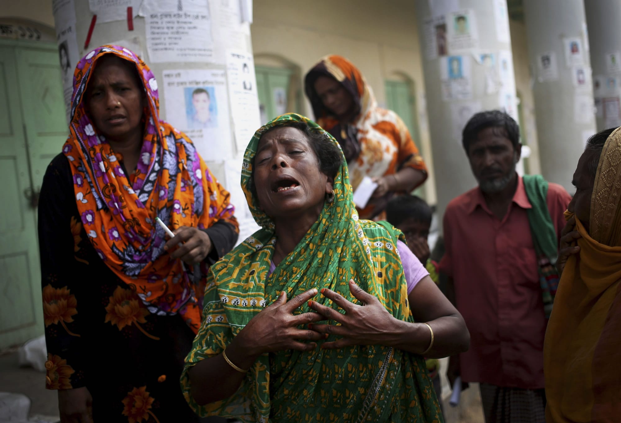 A woman grieves for her late relative after his body was pulled from the rubble of a  collapsed garment factory building in Savar, near Dhaka, Bangladesh, on Saturday.