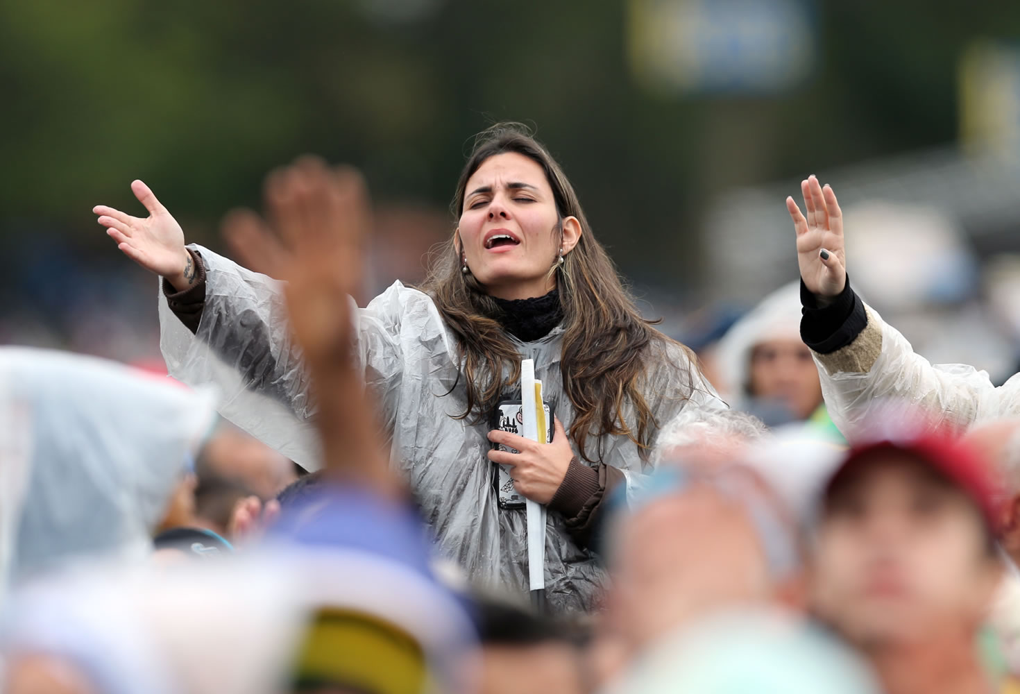 A woman prays during a Mass celebrated by Pope Francis outside the Aparecida Basilica in Aparecida, Brazil, on Wednesday.