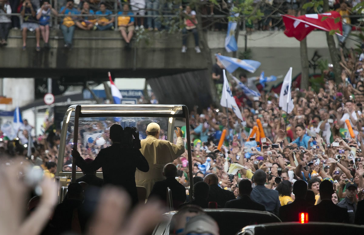 A crowd of faithful cheer as Pope Francis rides in his popemobile Monday in Rio de Janeiro, Brazil.