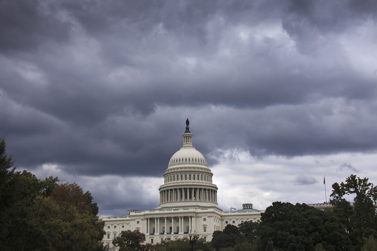 J.SCOTT APPLEwhite/Associated Press
Dark clouds hang over the U.S. Capitol on Saturday. A midnight Monday deadline is approaching for Congress to break an impasse over funding the government.