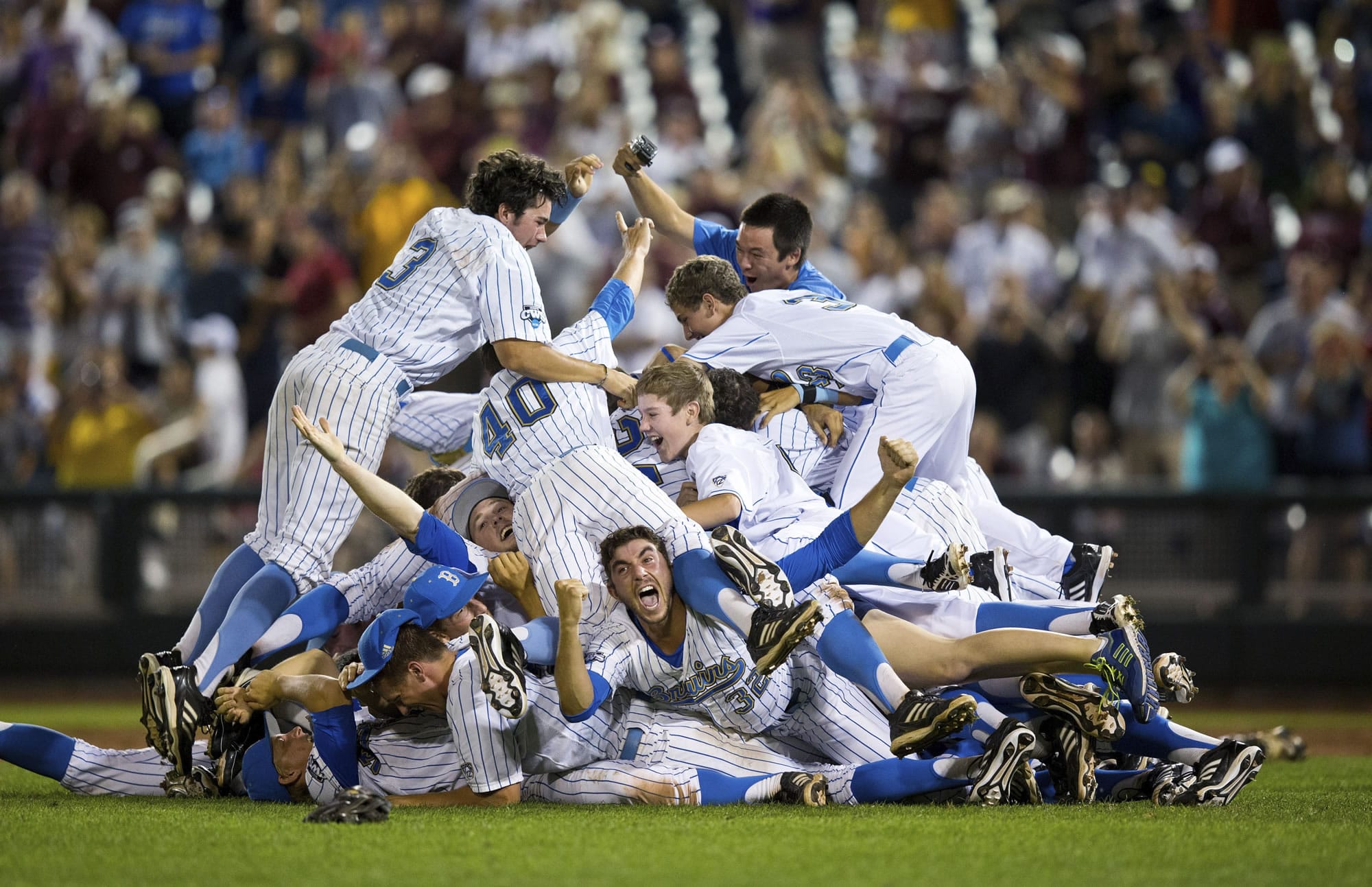 UCLA players celebrate winning the College World Series title after defeated Mississippi State 8-0 in Game 2 at Omaha, Neb., sweeping the best-of-three series.