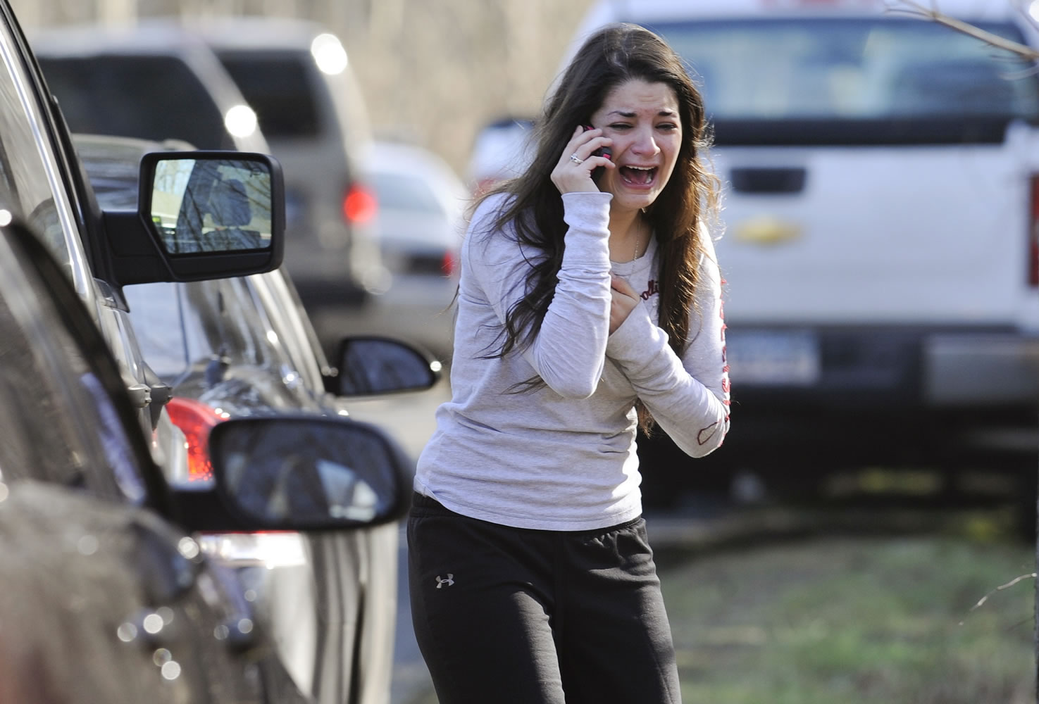Jillian Soto uses a phone to get information about her sister, Victoria Soto, a teacher at the Sandy Hook elementary school in Newtown, Conn., on Friday after a gunman killed over two dozen people, including 20 children.