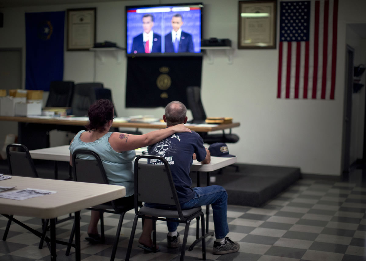 Dawn, left, and Randy Cornell watch the presidential debate Wednesday night at the United Steelworkers Local 4856 Union Hall in Henderson, Nev.