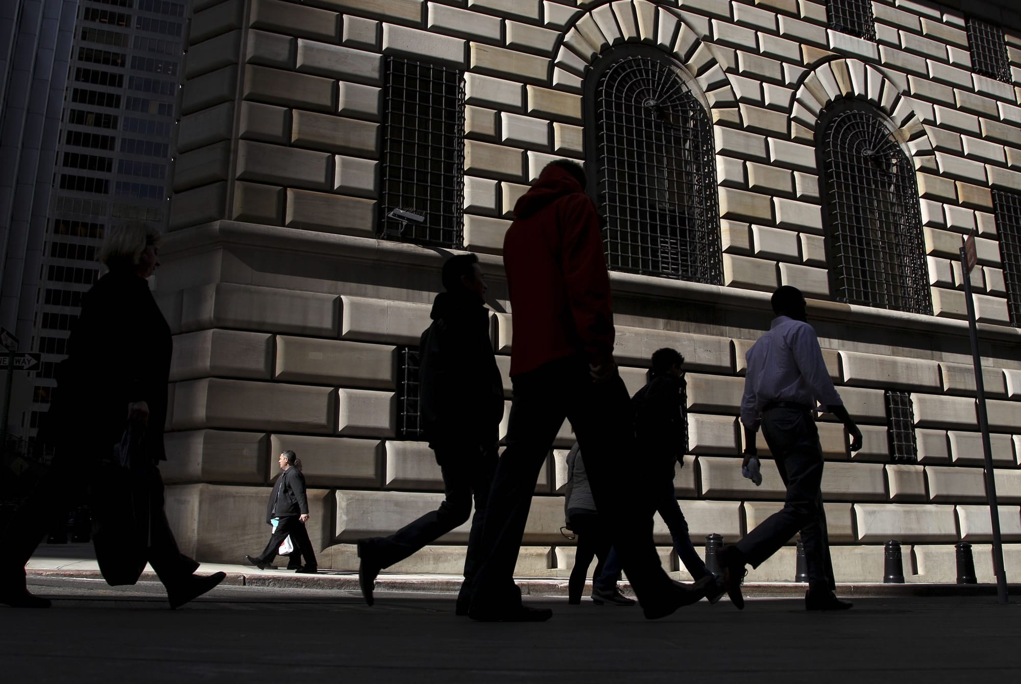 Pedestrians walk past the Federal Reserve Bank of New York in New York on Thursday.