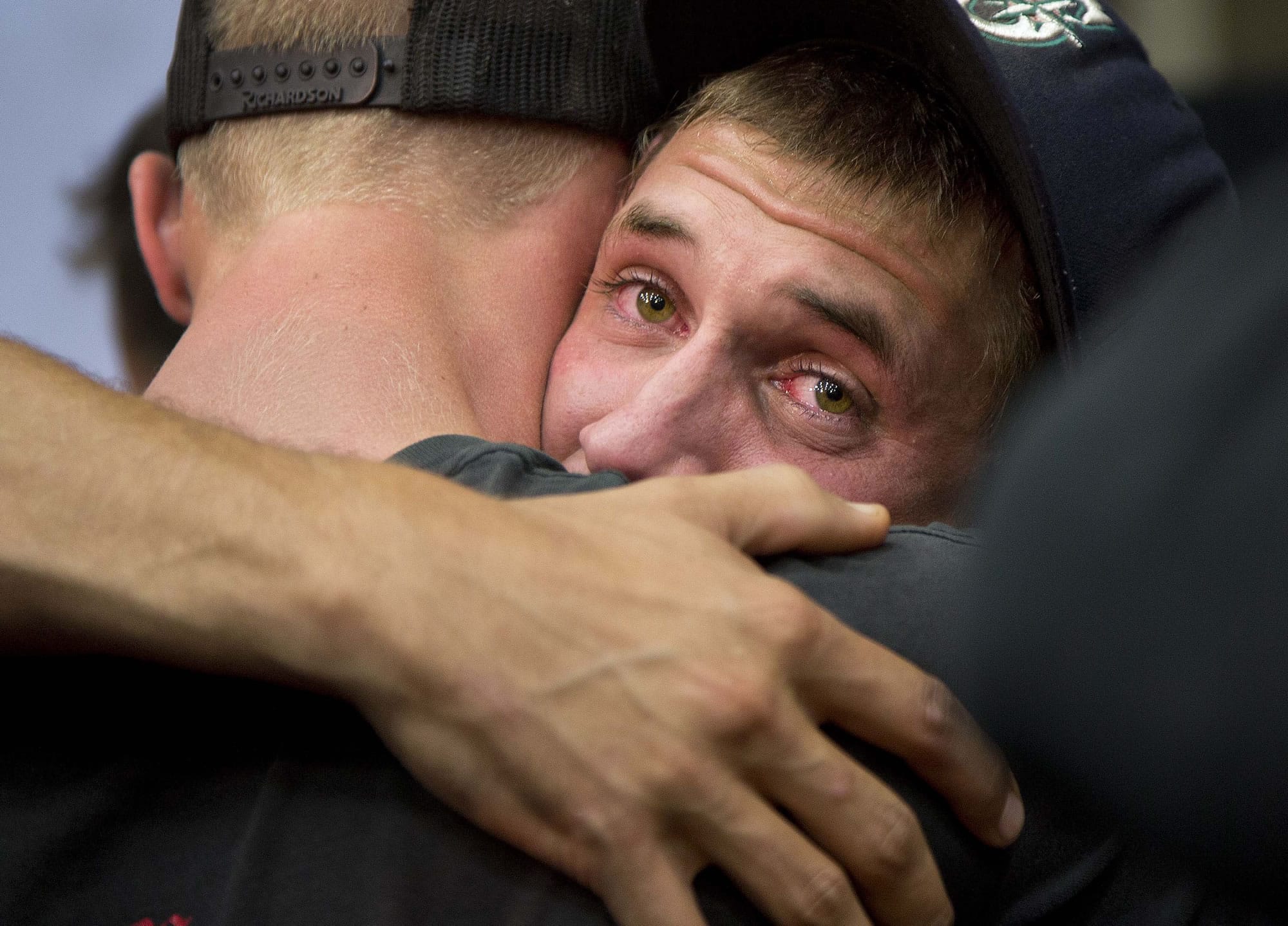 Prescott and other area department firefighters embrace during a memorial service Monday in Prescott, Ariz.
