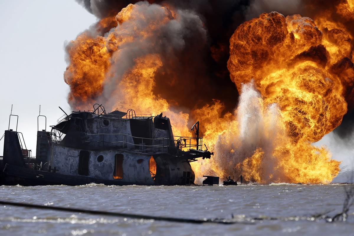 A fire still burns Wednesday after a tugboat and barge hit a gas pipeline Tuesday evening in Perot Bay in Lafourche Parish, La., about 30 miles south of New Orleans. Coast Guard Cmdr. Russ Bowen said it appears the barge is intact and none of its cargo of crude oil was leaking, though there were patches of oily sheen in the area.