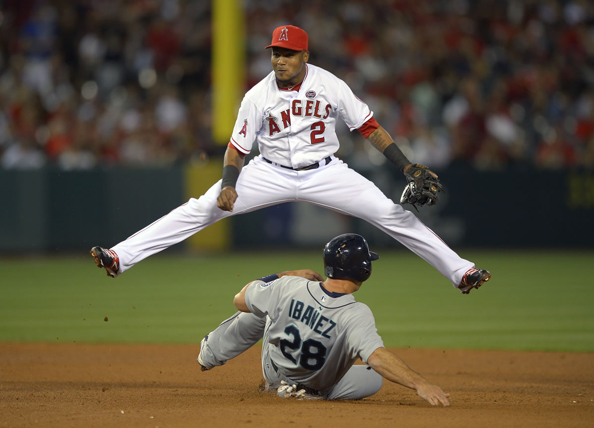 Seattle Mariners' Raul Ibanez, below, is forced out at second as Los Angeles Angels shortstop Erick Aybar throws out Mike Zunino at first during the fifth inning of their baseball game, Wednesday, June 19, 2013, in Anaheim, Calif.  (AP Photo/Mark J.