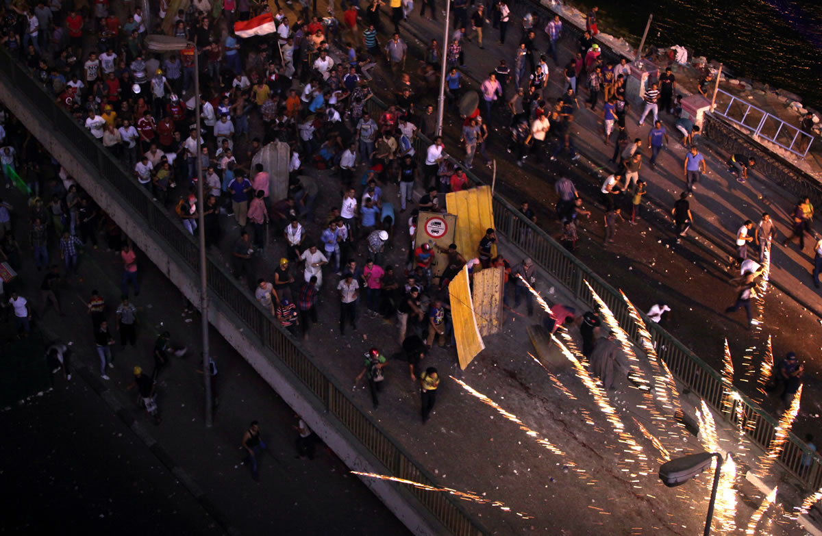 Supporters and opponents of Egypt's ousted Islamist president, Mohammed Morsi, clash on the 6 October bridge Friday Cairo, Egypt.