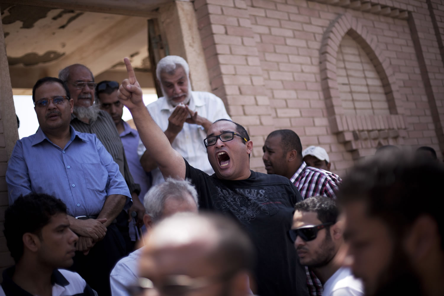 A friend of Ammar Badie, 38, who was killed Friday by Egyptian security forces during clashes in Ramses Square, shouts, &quot;Allah is the greatest,&quot; while attending Badie's burial Sunday in Cairo's Katameya district.