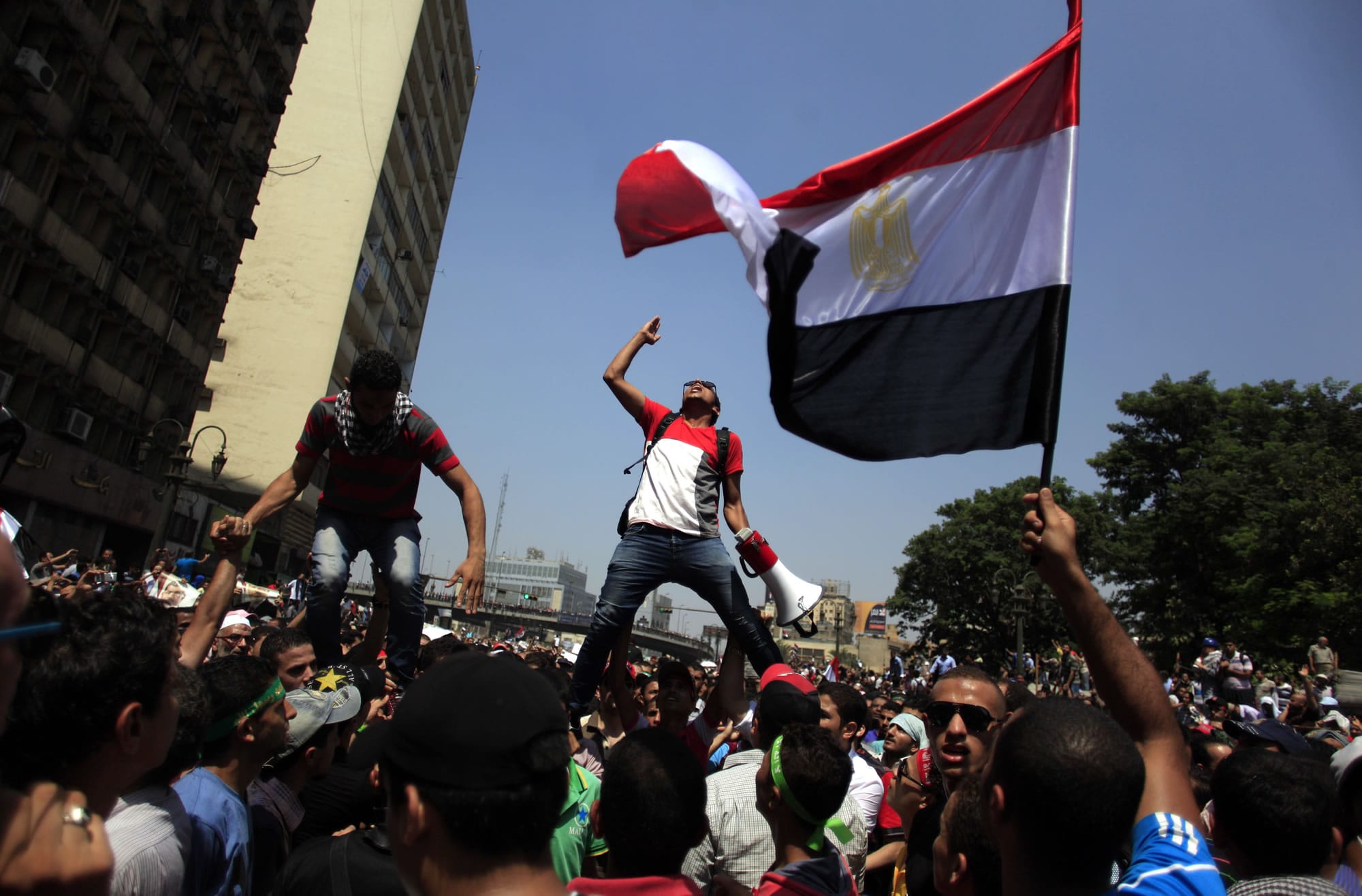 Supporters of Egypt's ousted President Mohammed Morsi chant slogans Friday during a protest in Ramses Square in downtown Cairo, Egypt. Heavy gunfire rang out Friday throughout Cairo as tens of thousands of Muslim Brotherhood supporters clashed with vigilante residents in the fiercest street battles to engulf the capital since the country's Arab Spring uprising.
