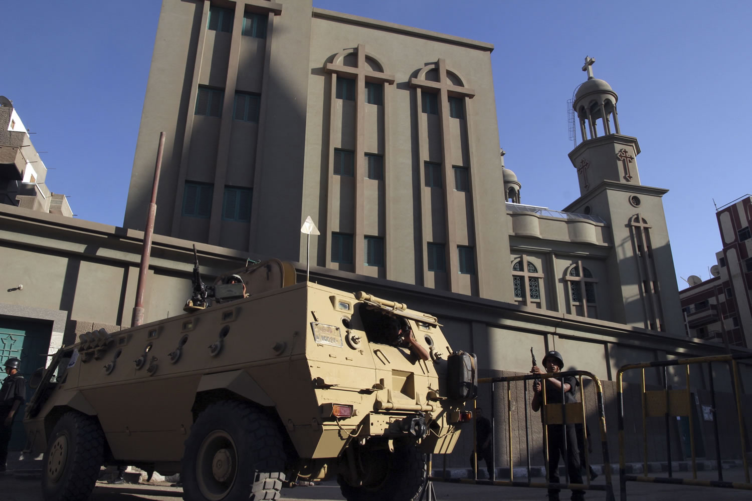 An Egyptian armored vehicle and army soldiers stand guard outside the main Christian Orthodox Cathedral in the southern city of Assiut, Egypt, on Sunday.