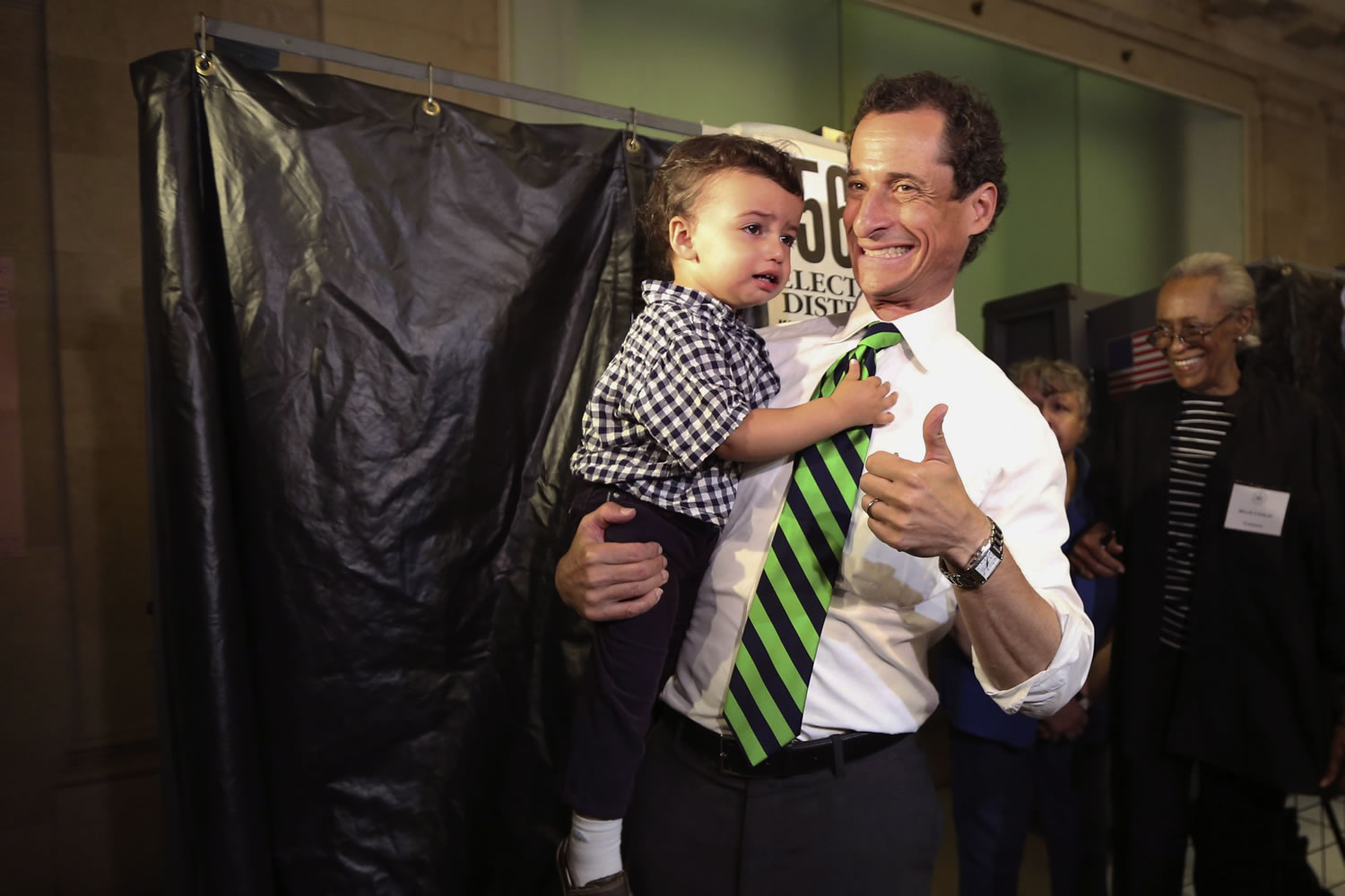 Democratic mayoral hopeful Anthony Weiner holds his son, Jordan, as he leaves the voting booth after casting his vote at his polling station during the primary election in New York on Tuesday.