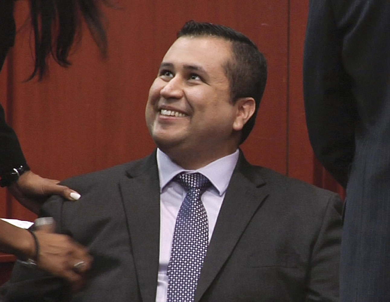 George Zimmerman smiles after a not guilty verdict was handed down in his trial at the Seminole County Courthouse in Sanford, Fla.
