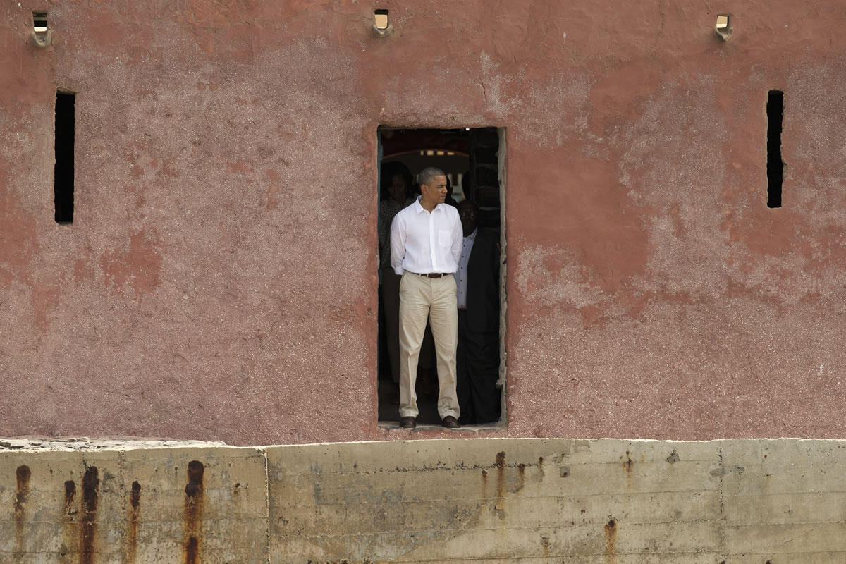 U.S. President Barack Obama stands facing out to see,  at the 'Door of No Return,' at the slave house on Goree Island, in Dakar, Senegal, on Thursday.