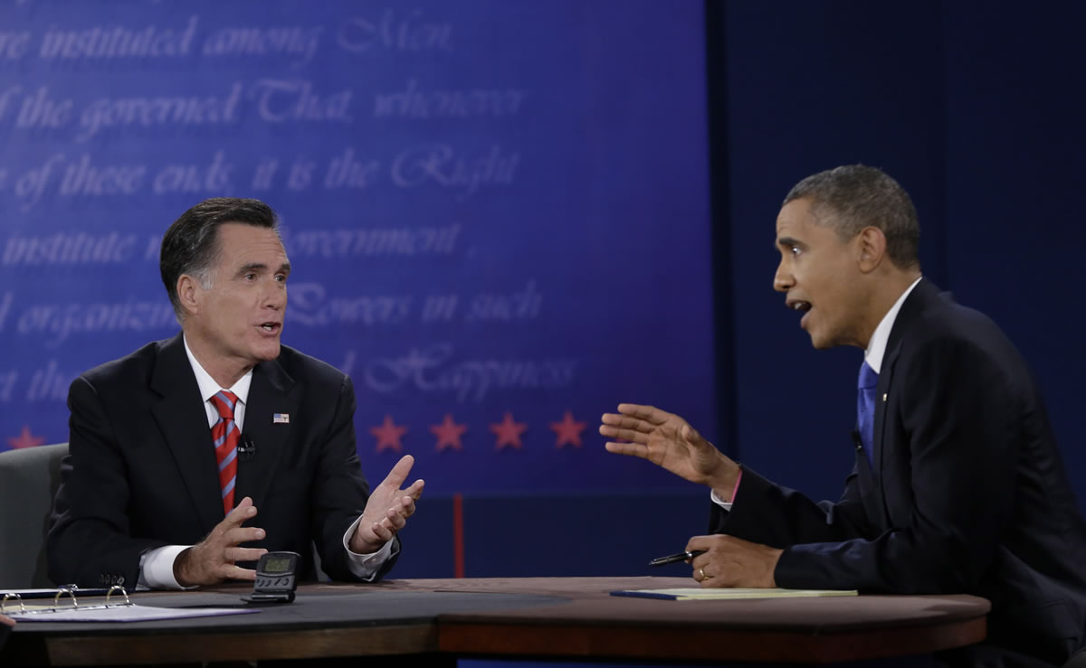 President Barack Obama, right, and Republican presidential nominee Mitt Romney discuss a point during the third presidential debate at Lynn University, Monday, Oct. 22, 2012, in Boca Raton, Fla.