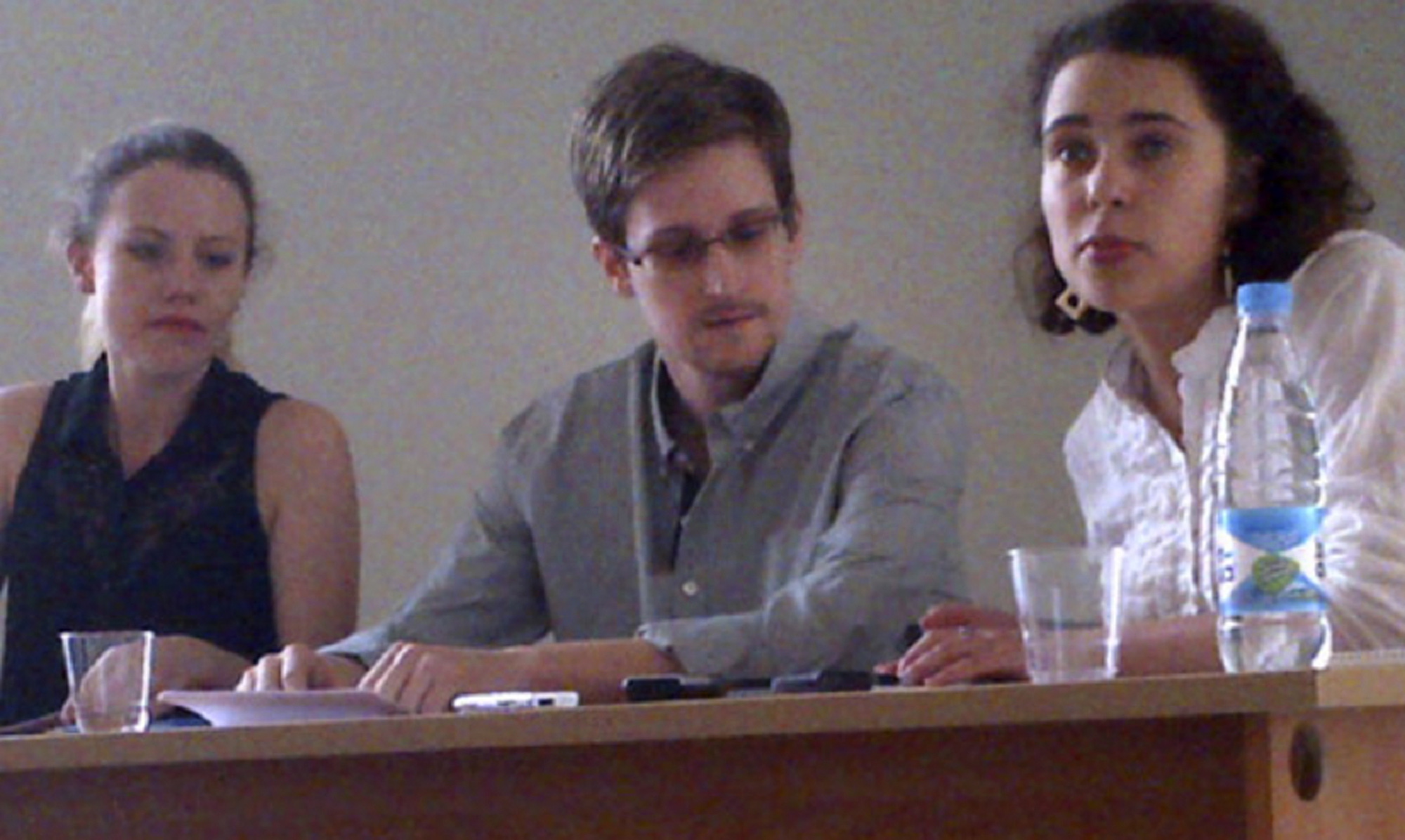 NSA leaker Edward Snowden, center, attends a news conference at Moscow's Sheremetyevo Airport with Sarah Harrison of WikiLeaks, left, on Friday.