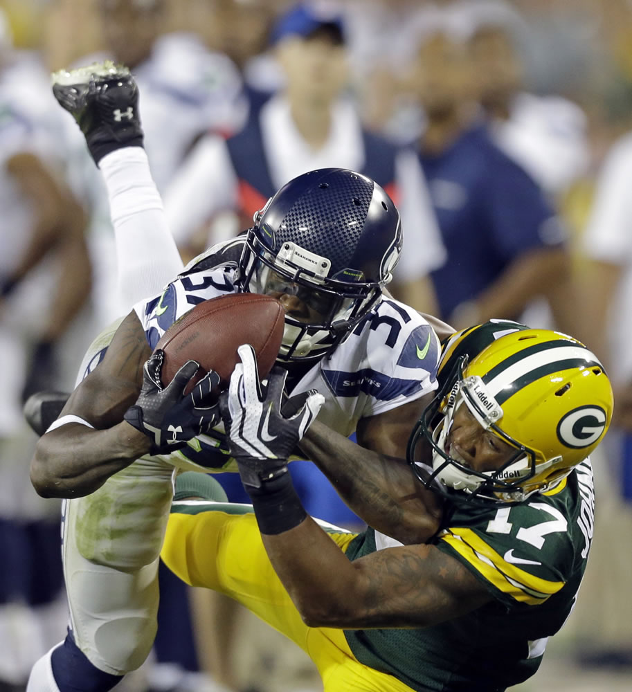 Seattle Seahawks' Will Blackmon catches a ball in front of Green Bay Packers' Charles Johnson during the second half Friday.