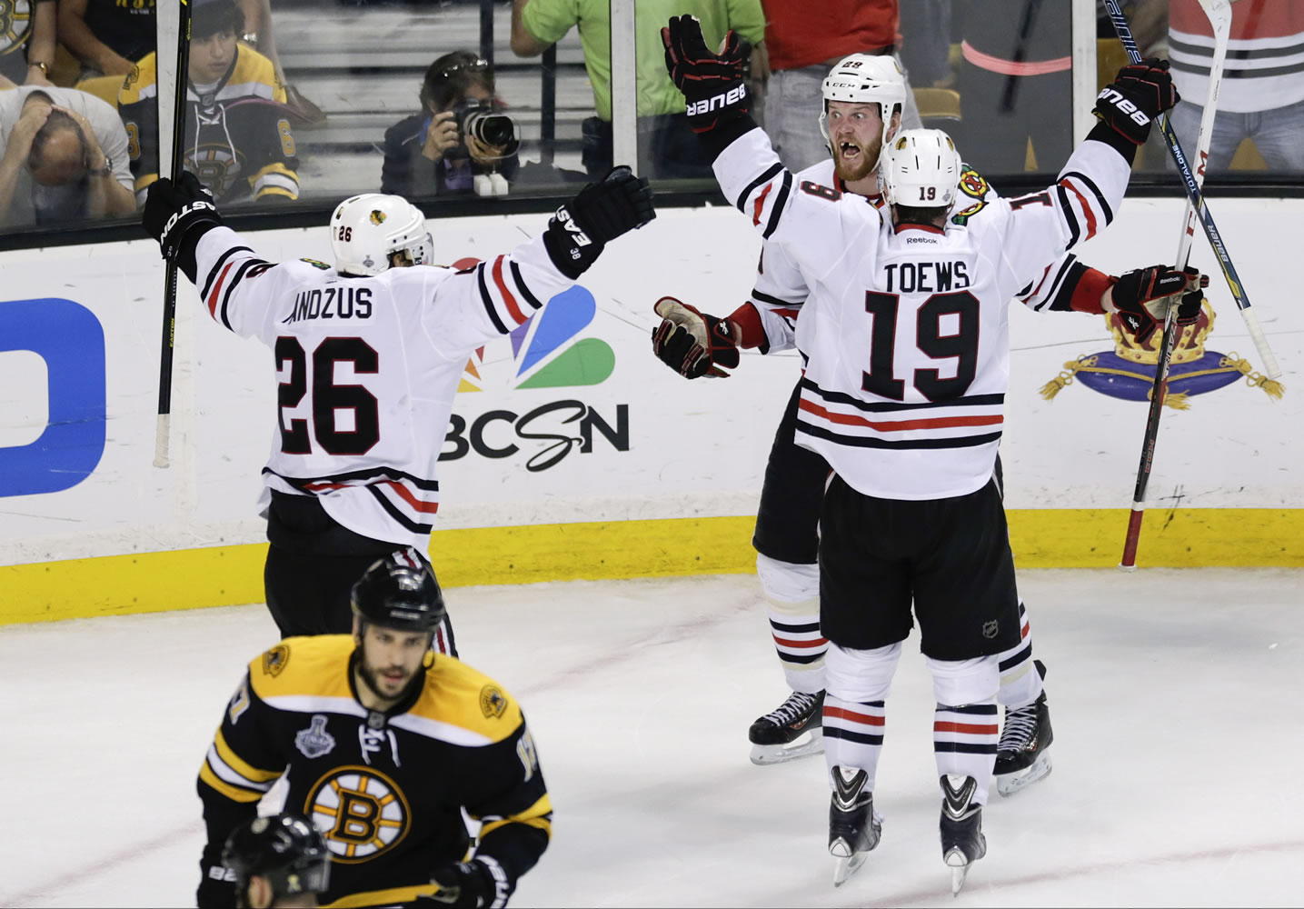 Chicago Blackhawks left wing Bryan Bickell, center, celebrates his goal with Jonathan Toews (19) and Michal Handzus (26) during the third period in Game 6 on Monday.