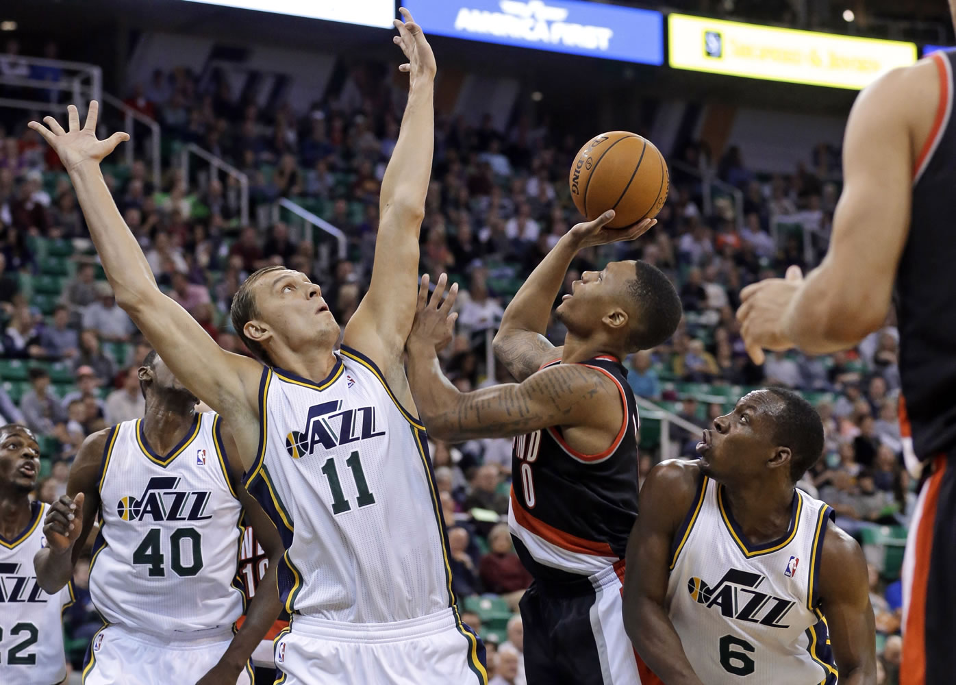 Portland Trail Blazers' Damian Lillard shoots as Utah Jazz's Andris Biedrins (11) defends during the second quarter  Wednesday in Salt Lake City.