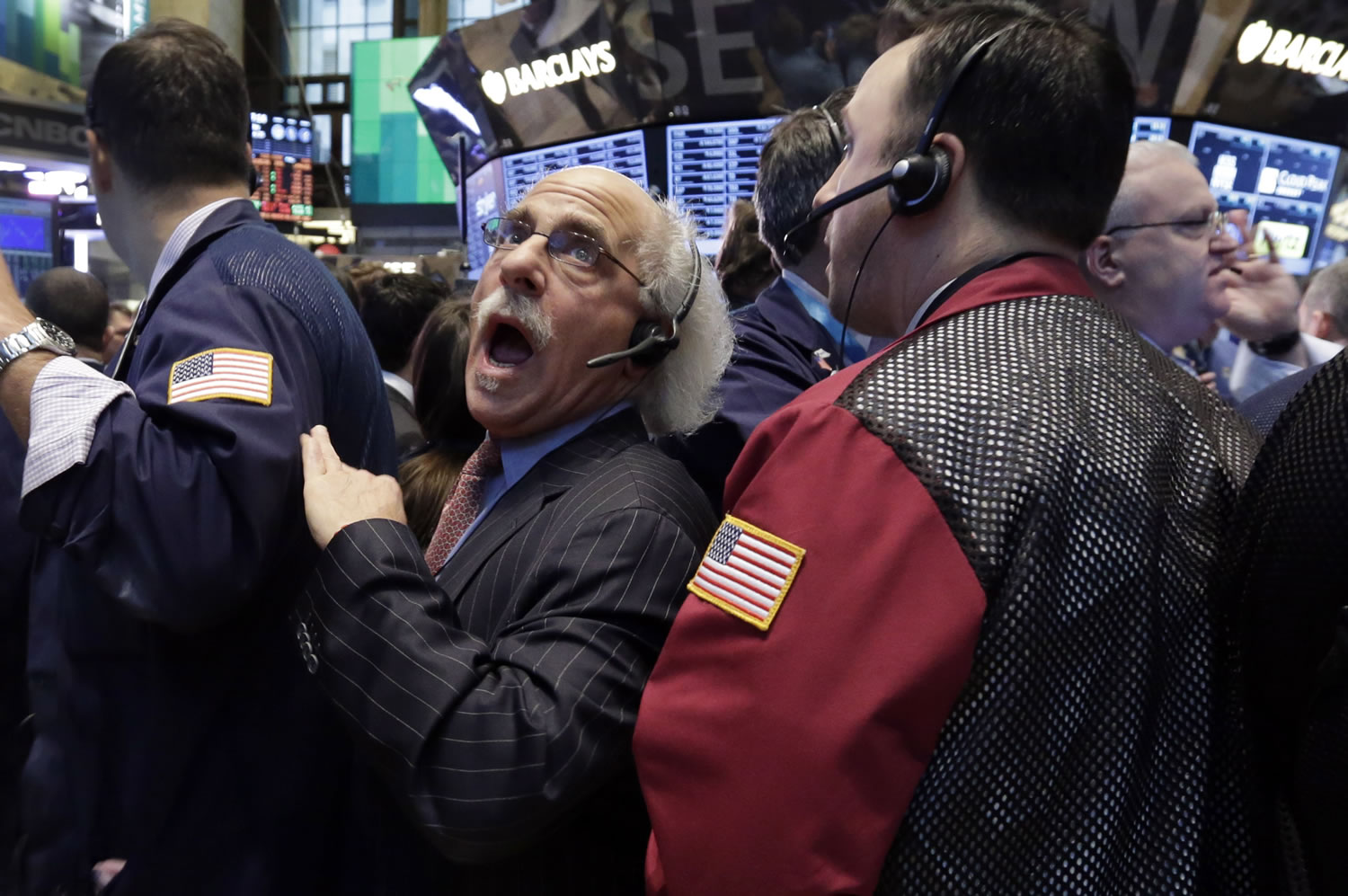 Trader Peter Tuchman, center, works Friday on the floor of the New York Stock Exchange.