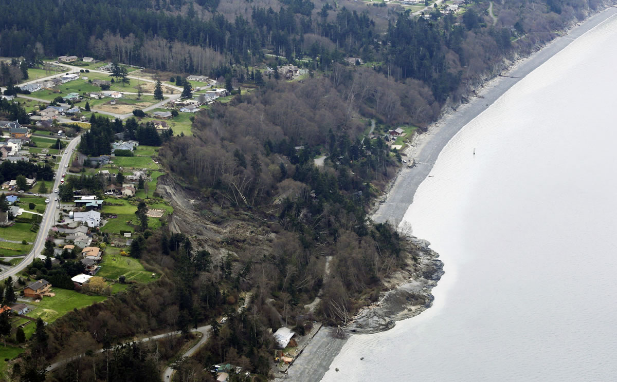 An aerial photo shows a landslide near Coupeville on Whidbey Island on Wednesday. The slide severely damaged one home and isolated or threatened more than 30 on the island, about 50 miles north of Seattle in Puget Sound. No one was reported injured in the slide, which happened at about 4 a.m.