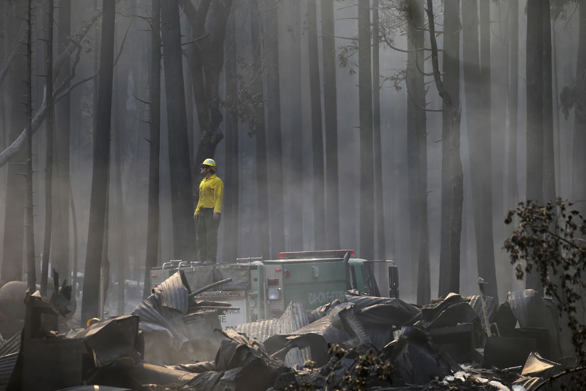 A firefighter stands on top of a fire truck at a campground destroyed by the Rim Fire near Yosemite National Park, Calif., on Monday.