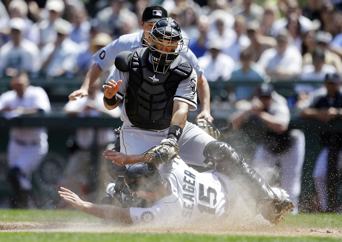 White Sox catcher Hector Gimenez tags out the Mariners' Kyle Seager (15) at home to end the fourth inning.