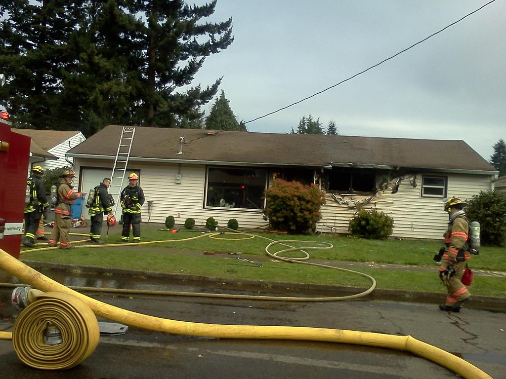 Vancouver firefighters work at the scene of a house fire on Wahclellah Avenue this afternoon.