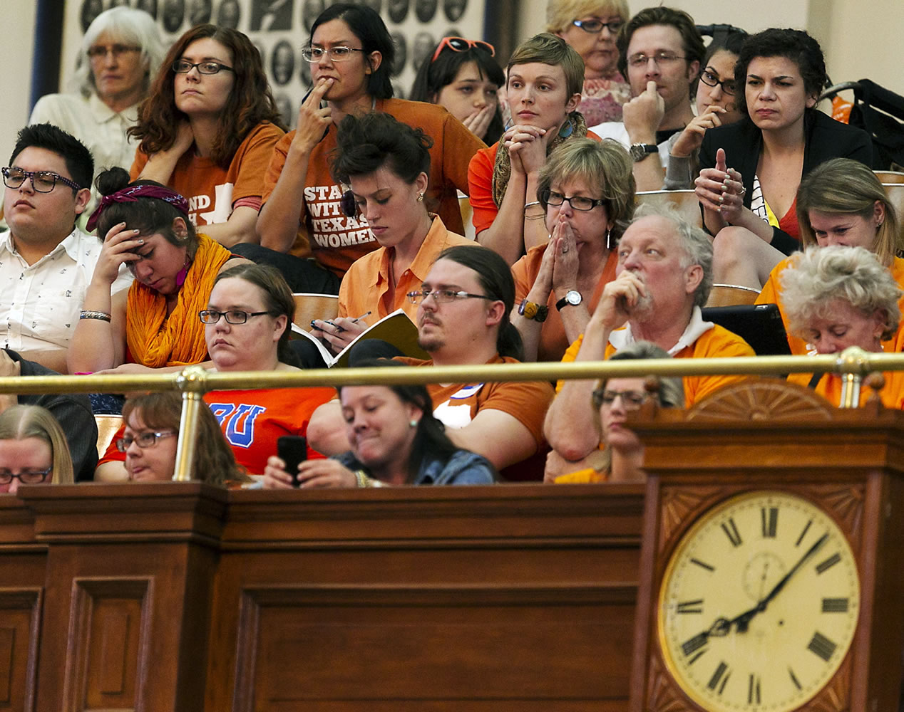 Women's rights protesters react in gallery of the House of Representative Chambers as State Rep.