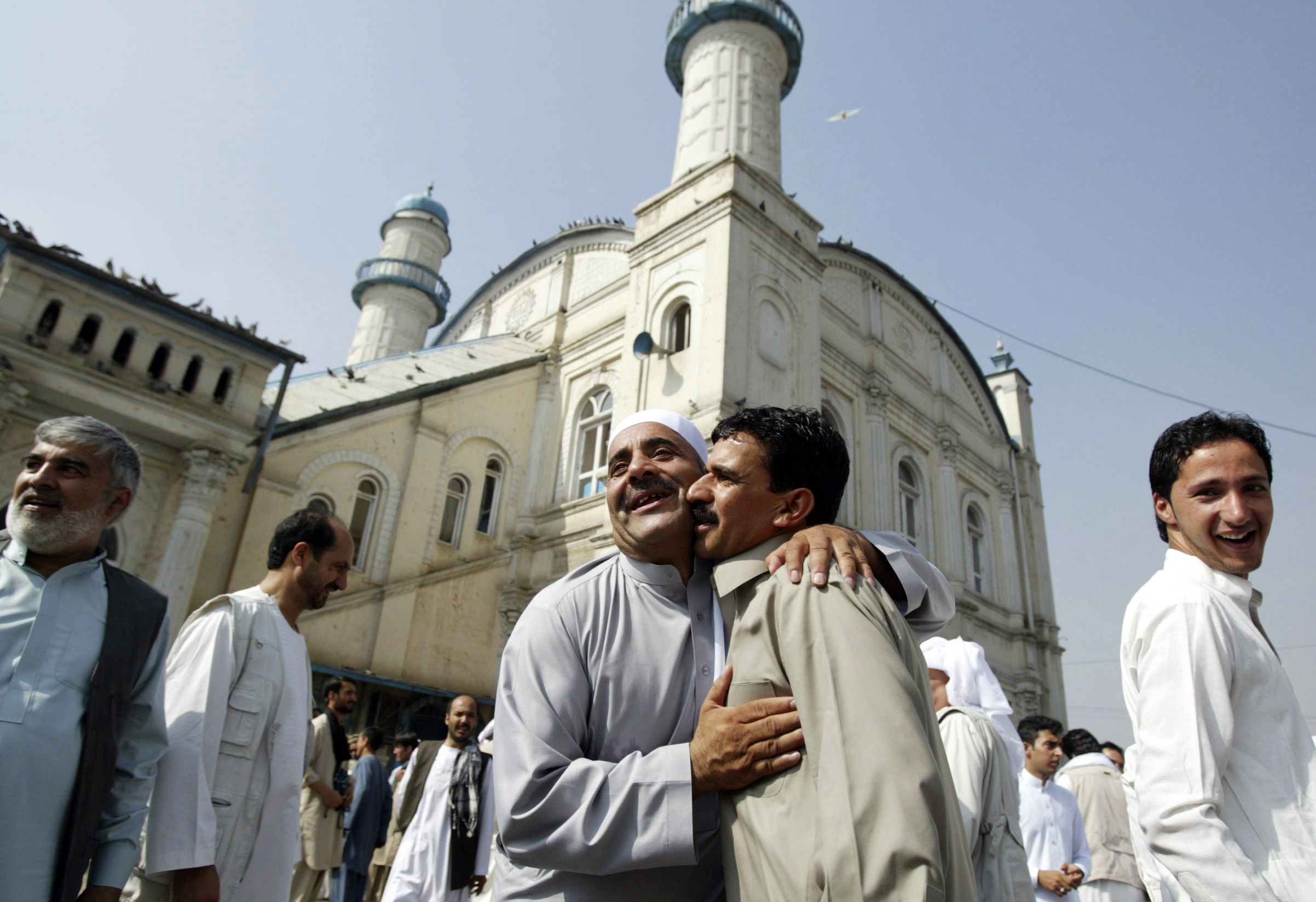 Afghans celebrate the Eid al Adha with each other after offering Eid al Adha's prayers outside Shah-e-Dushamshera mosque in Kabul, Afghanistan, on Thursday.