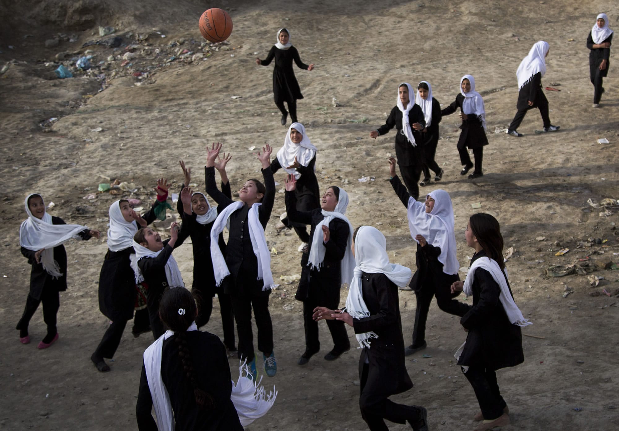 Afghani schoolgirls play volleyball with a basketball during a break at their girls school in the old town of Kabul, on Sunday. In the past twelve years, many girls have returned to school in Afghanistan.
