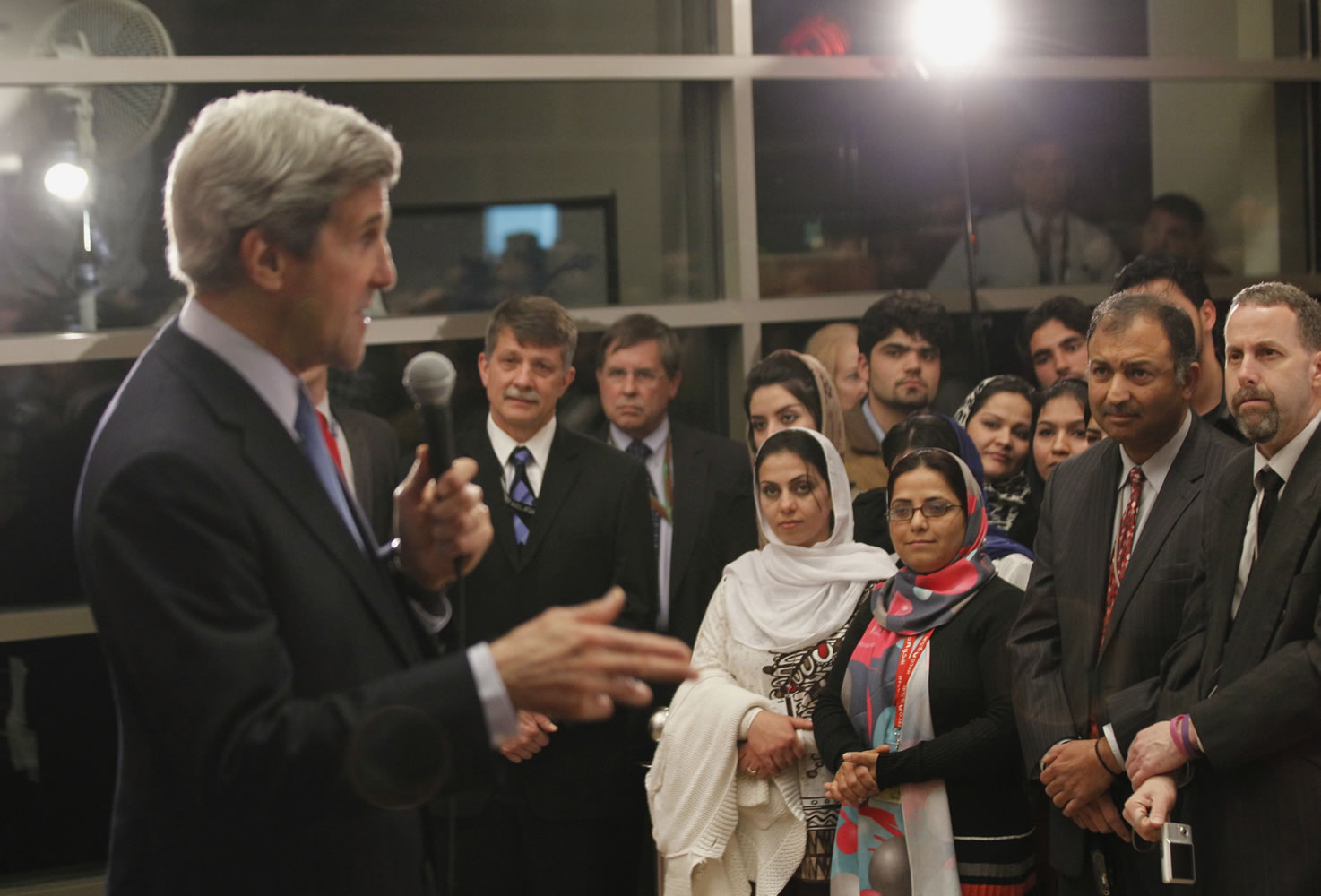 U.S. Secretary of State John Kerry talks to staff during his visit to the U.S.