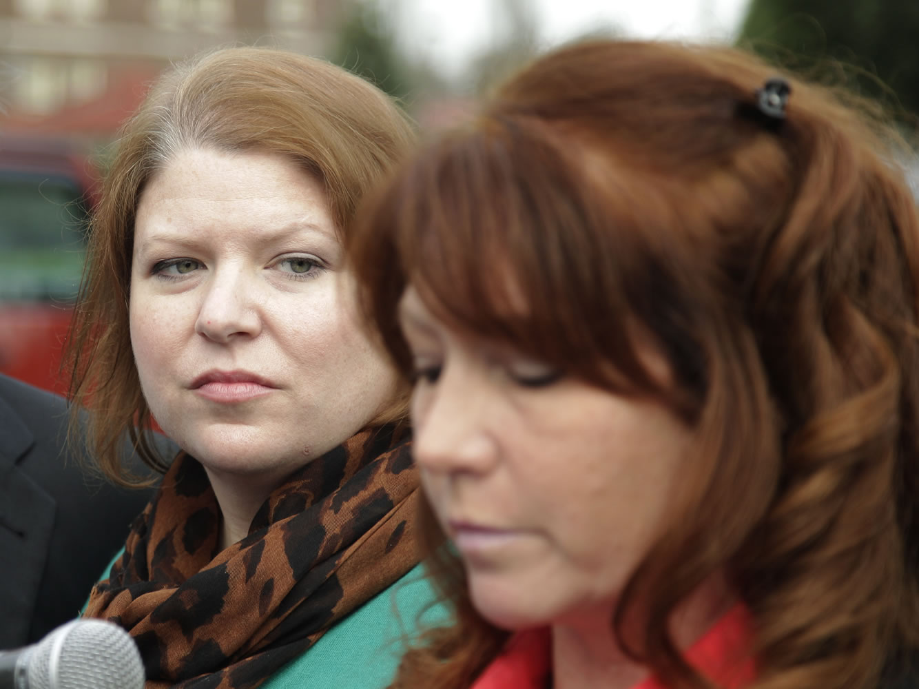 Kari Bales, left, listens as her sister, Stephanie Tandberg, reads a statement to reporters Tuesday outside the military courtroom where a preliminary hearing had just ended for Bales' husband, U.S. Army Staff Sgt.