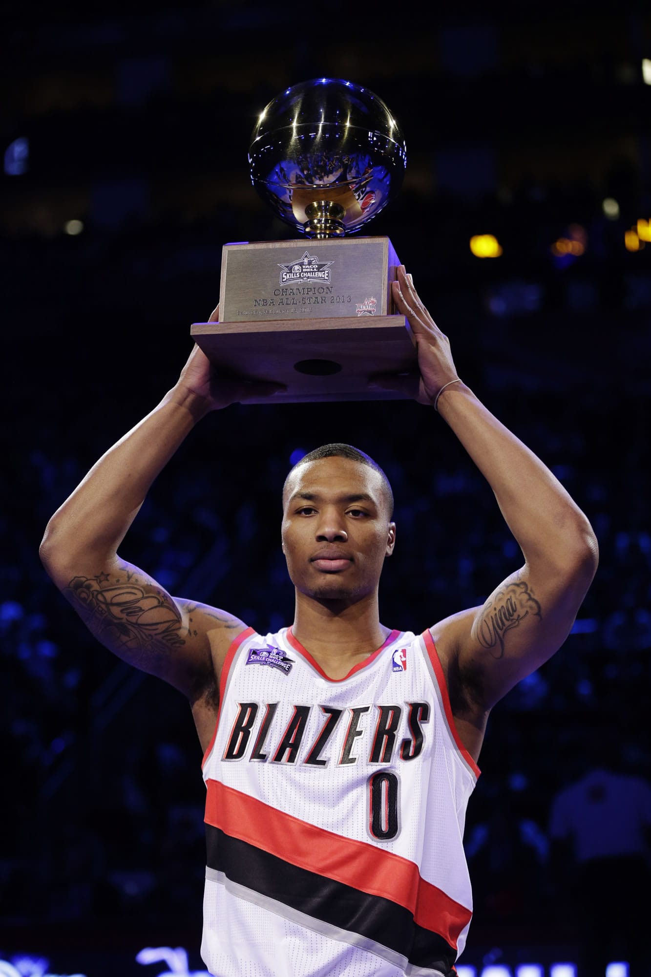 Damian Lillard of the Portland Trail Blazers raises the trophy after winning the skills challenge during NBA basketball All-Star Saturday Night in Houston.