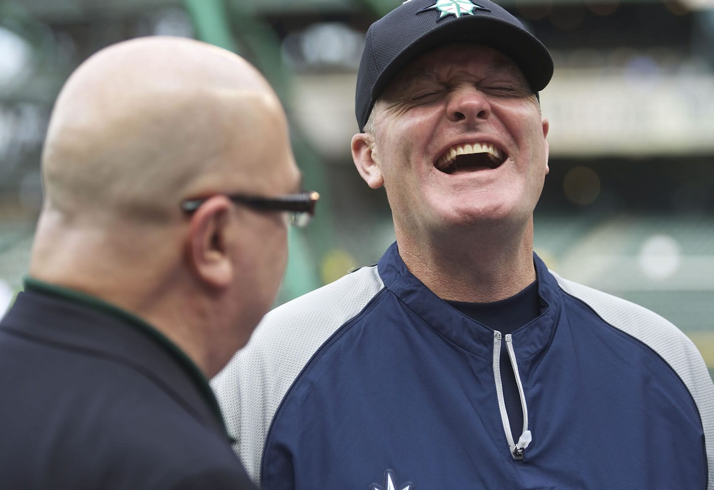 Seattle Mariners manager Eric Wedge, right, laughs while talking with general manager Jack Zduriencik before the Friday's game against the Los Angeles Angels.