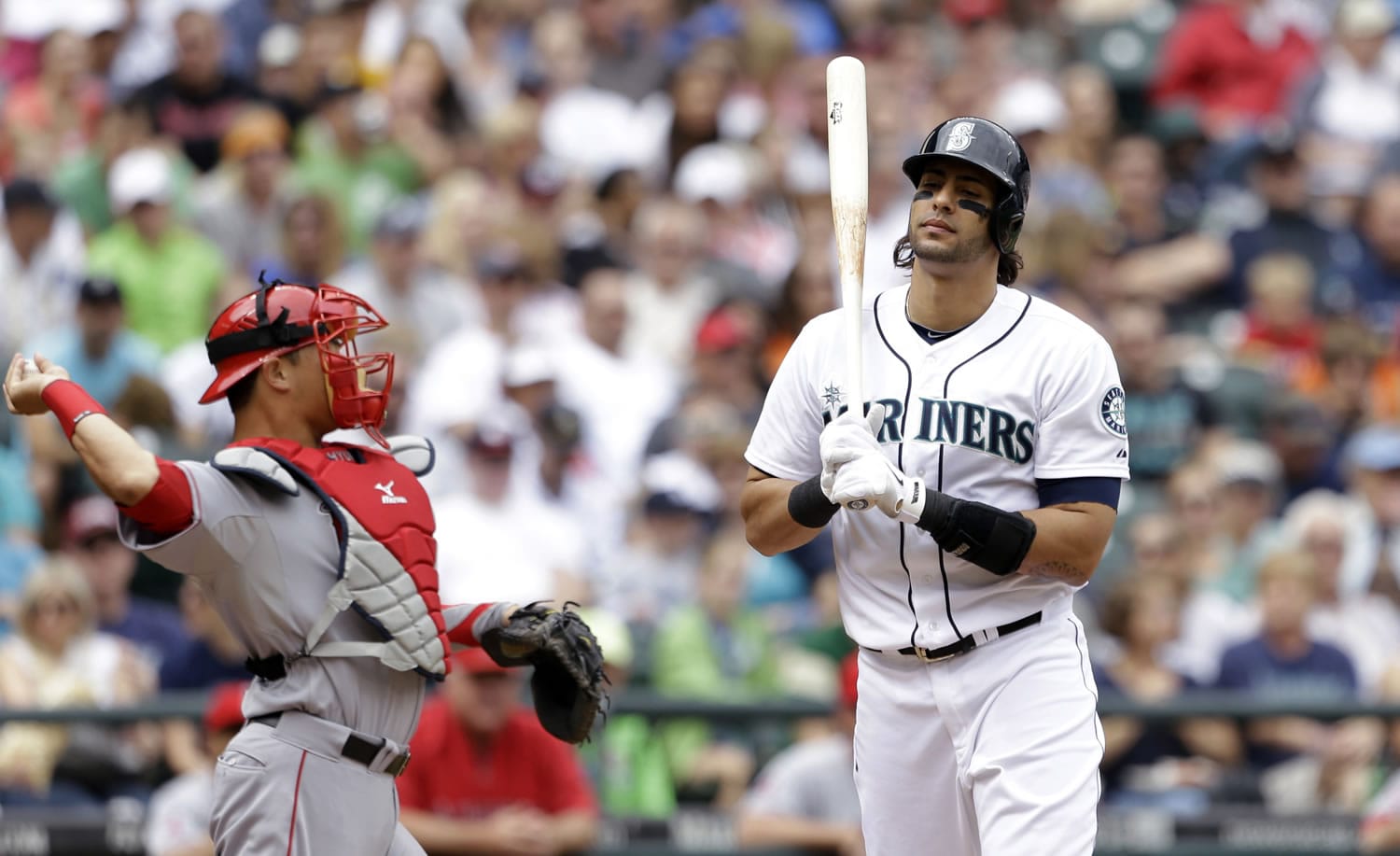 Seattle Mariners' Michael Morse, right, turns toward the dugout after striking out in the third inning Sunday.