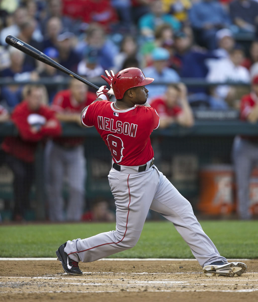 Los Angeles Angels' Chris Nelson follows through on a two-run home run during the second inning Friday.