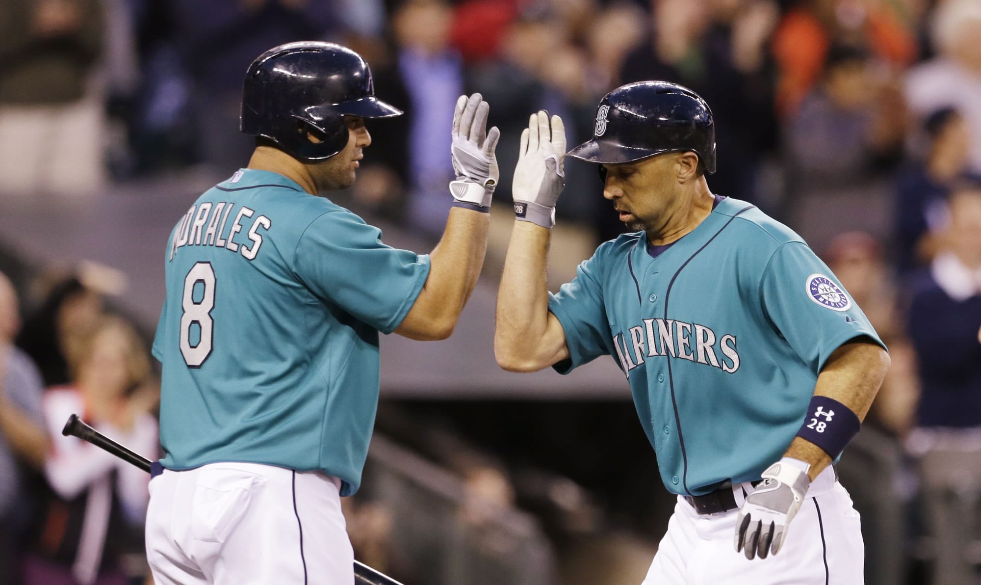 Seattle Mariners' Raul Ibanez, right, is congratulated by on-deck batter Kendrys Morales after Ibanez' home run against the Los Angeles Angels in the sevent inning of a baseball game Friday, July 12, 2013, in Seattle. Morales homered on his turn.