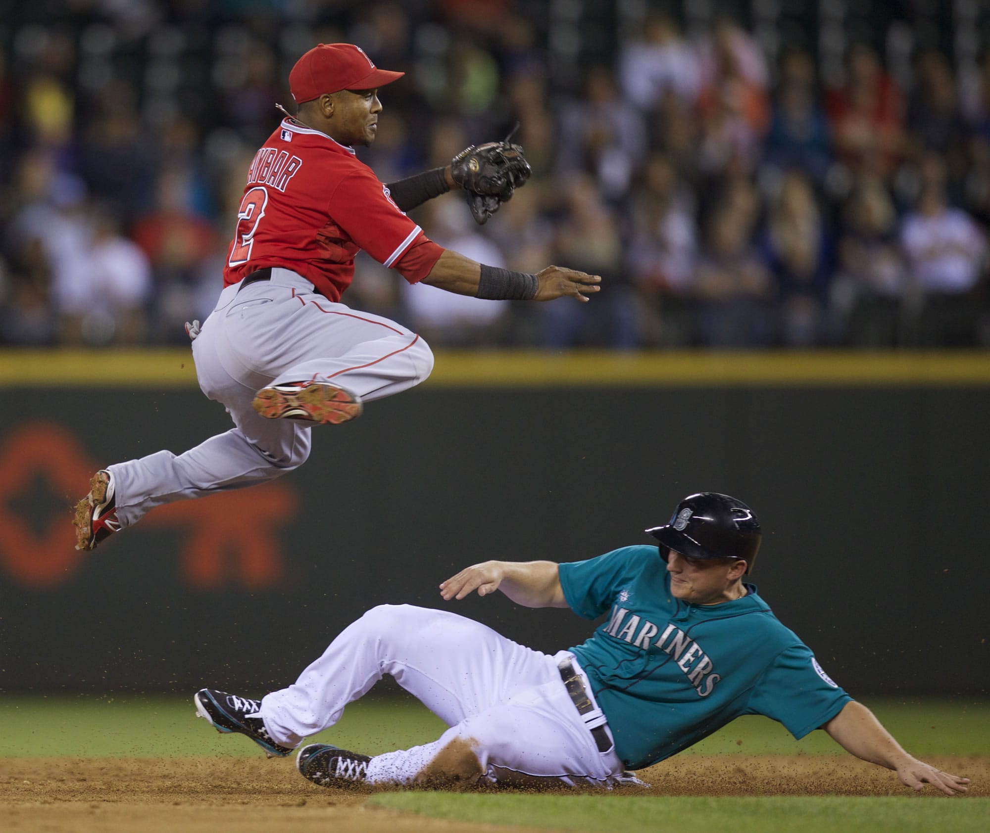 Los Angeles Angels shortstop Erick Aybar, left, completes a double play as Seattle Mariners' Kyle Seager slides into second base during the sixth inning Friday.