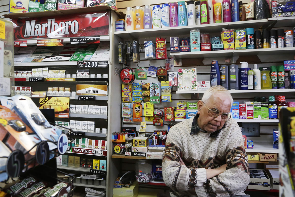 Harry Patel, an employee of Blondie's Deli and Grocery, talks on the phone while waiting for customers in New York on Monday. A new anti-smoking proposal would make New York the first city in the nation to keep tobacco products out of sight in retail stores.