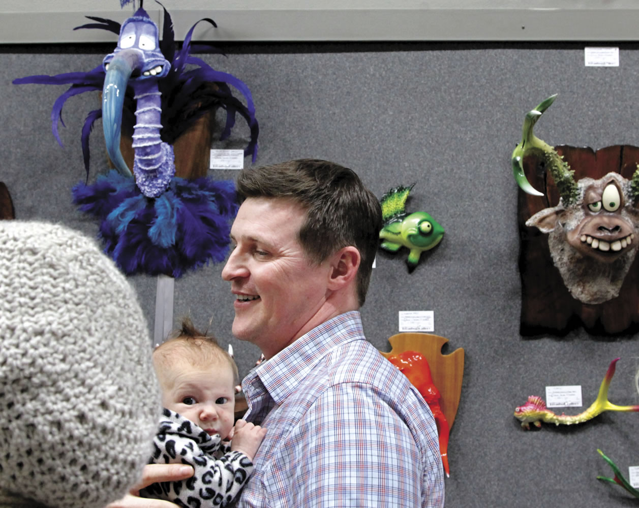 Artist and Cowlitz County Commissioner Jim Misner holds his daughter, Liberty.