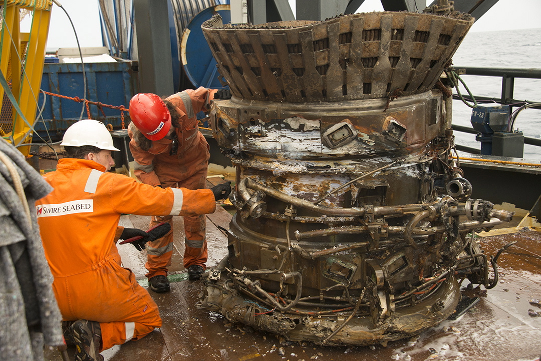 Photos by Bezos Expeditions
Workers inspect a thrust chamber from an Apollo F-1 engine recovered from the bottom of the Atlantic Ocean this month. An expedition led by Amazon CEO Jeff Bezos pulled up two rocket engines from the 1960s and 1970s, including this one, that helped boost Apollo astronauts to the moon.
