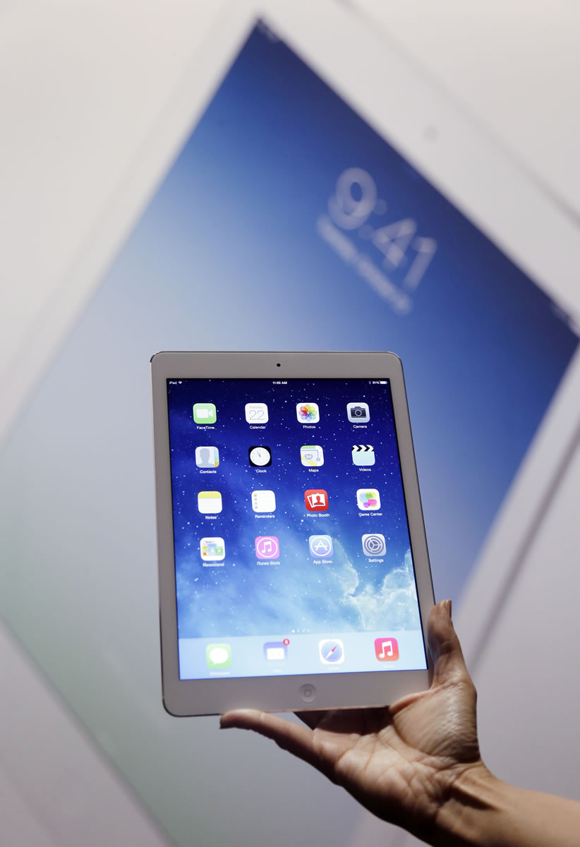 An Apple employee holds up the new iPad Air on Tuesday in San Francisco.