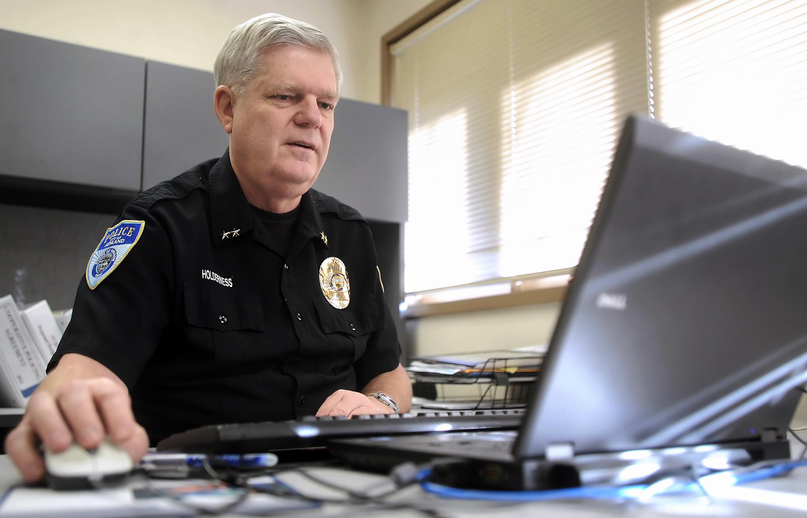 Julia Moore/The Medford Mail Tribune
Ashland police Chief Terry Holderness browses a new website that will encourage sexual assault victims to report attacks once it goes live in January in Ashland, Ore.