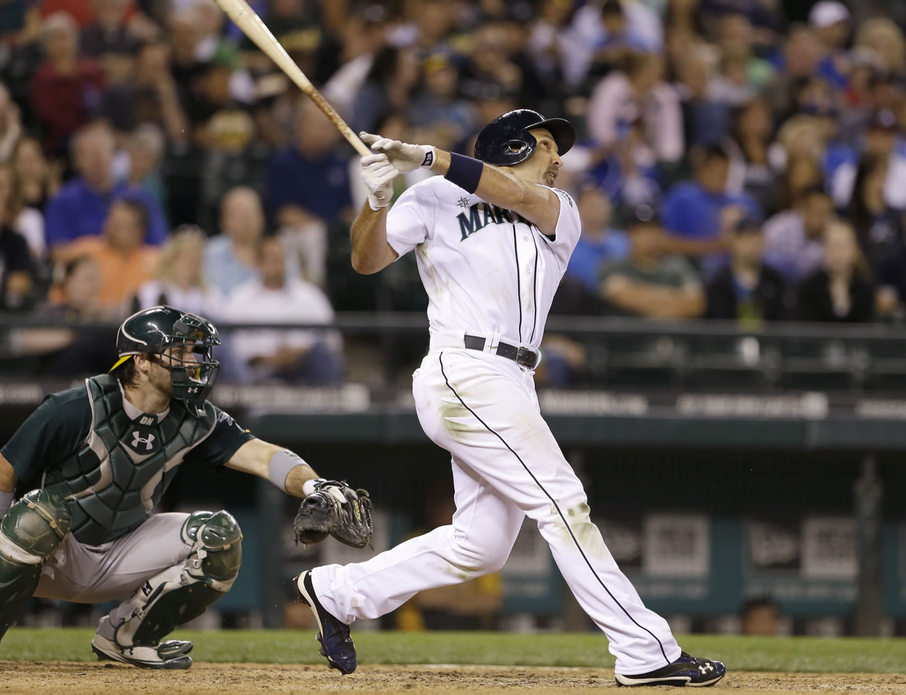 Seattle Mariners' Raul Ibanez homers in the seventh inning Saturday against the Oakland Athletics.