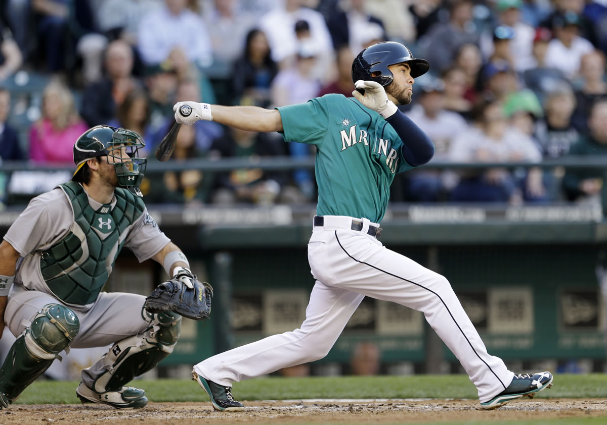 Seattle Mariners' Nick Franklin, right, watches the path of his three-run home run in the third inning Friday.