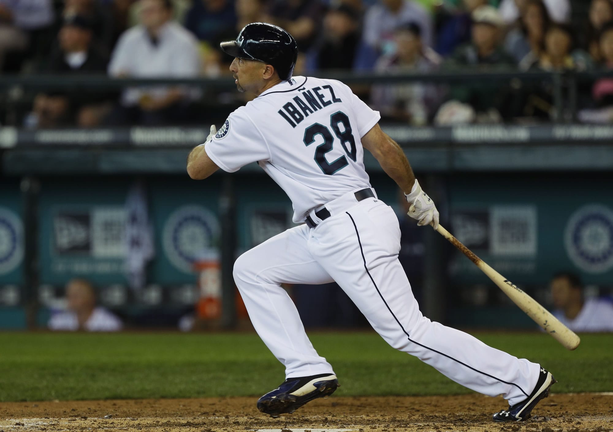 In the fourth inning Sunday, Seattle Mariners' Raul Ibanez watches as his second home run take flight against the Oakland Athletics.